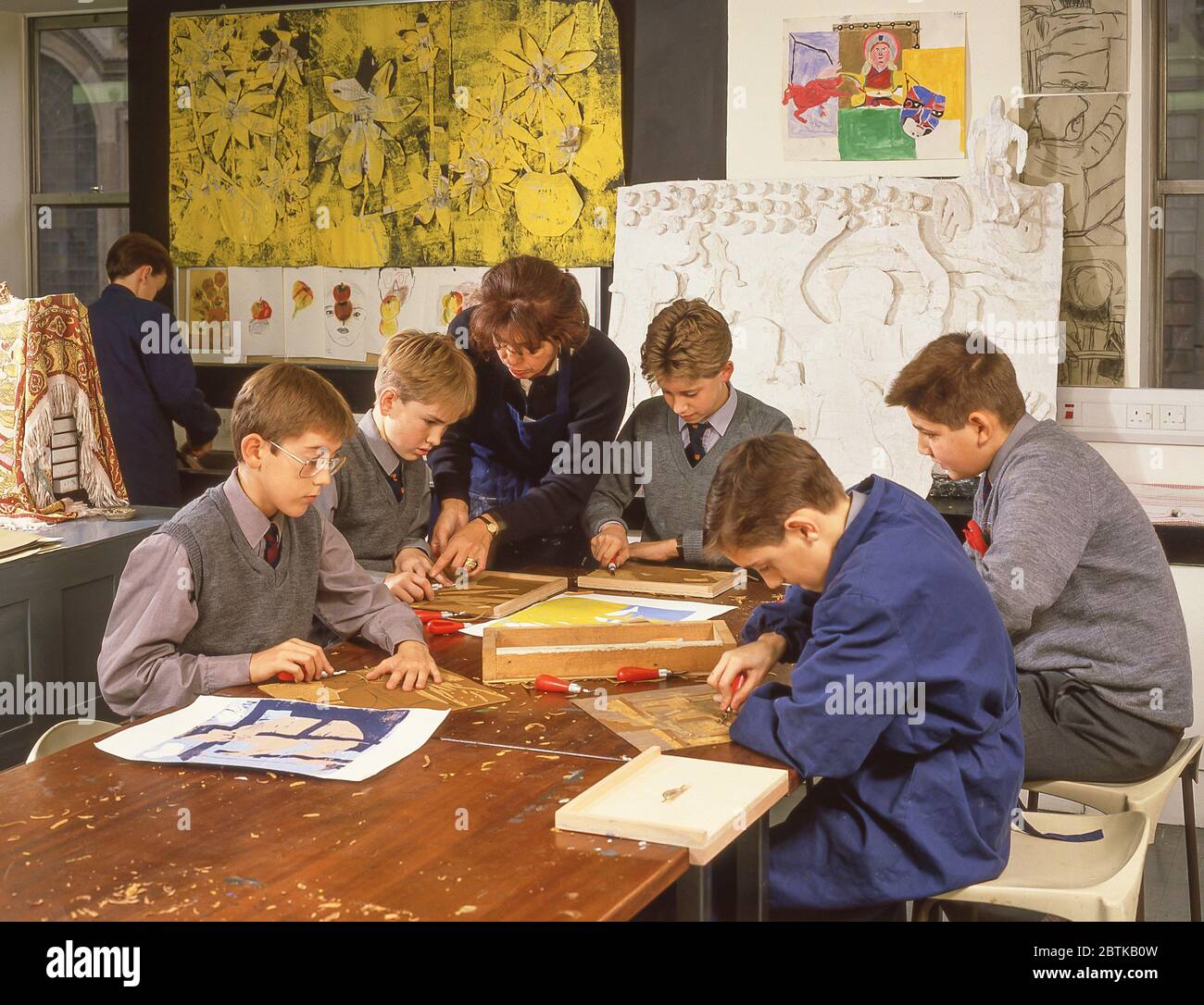 School boys lino cutting in arts & crafts class, Surrey, England ...