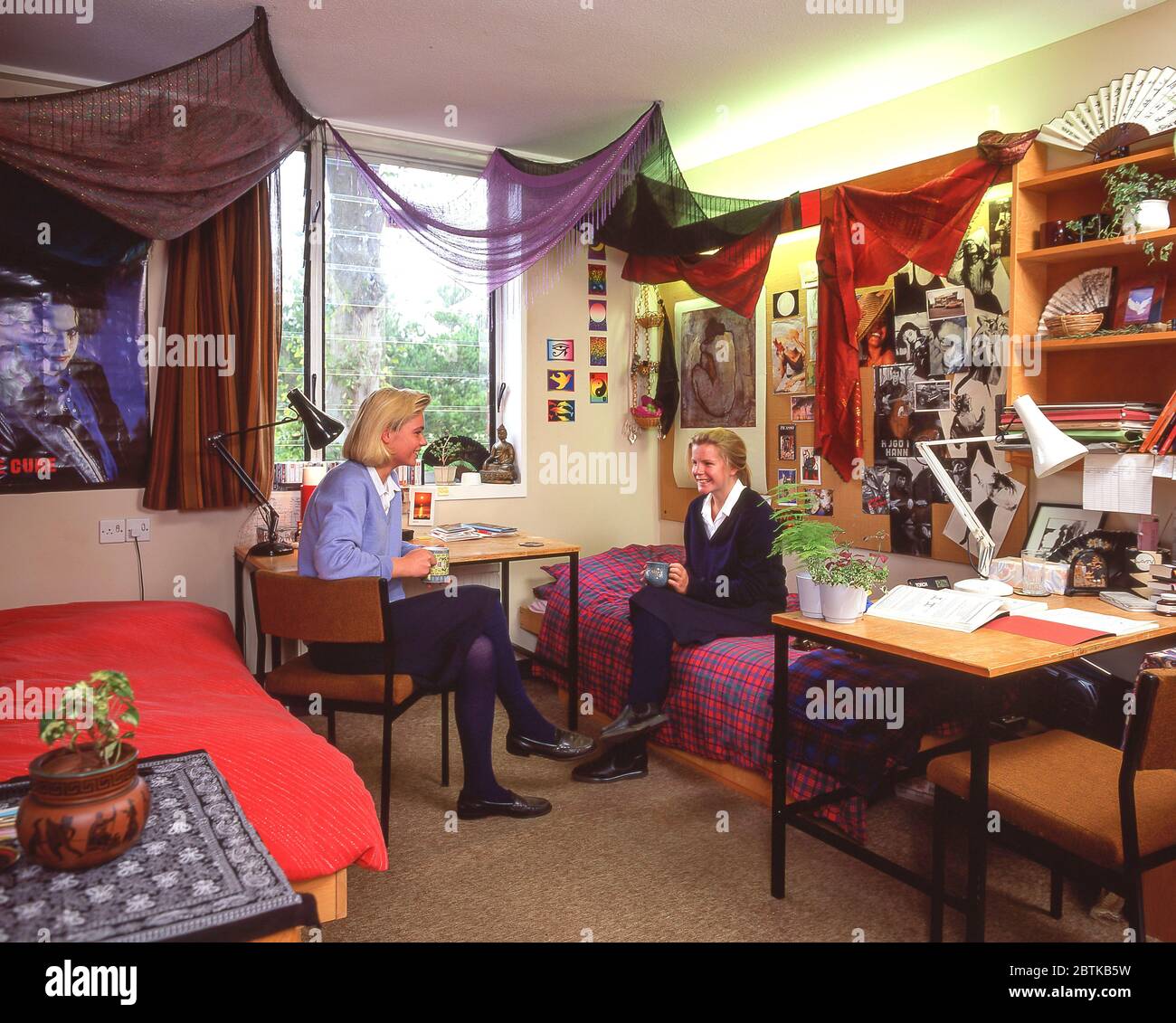 Secondary schoolgirls in dormitory at independent boarding school, Surrey, England, United Kingdom Stock Photo