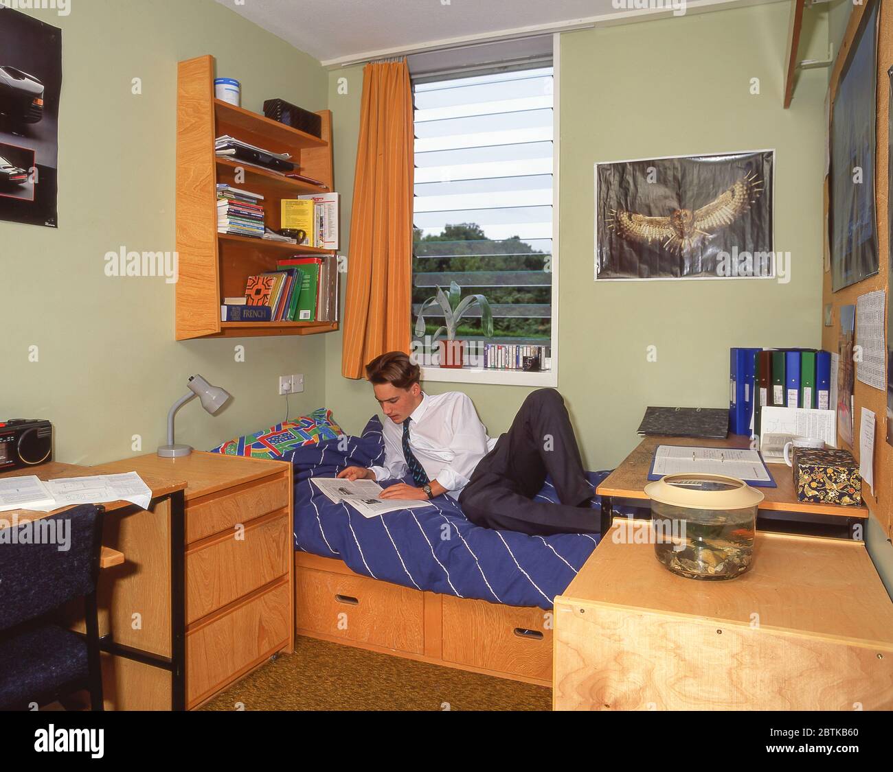 Secondary schoolboy in dormitory at independent boarding school, Surrey, England, United Kingdom Stock Photo