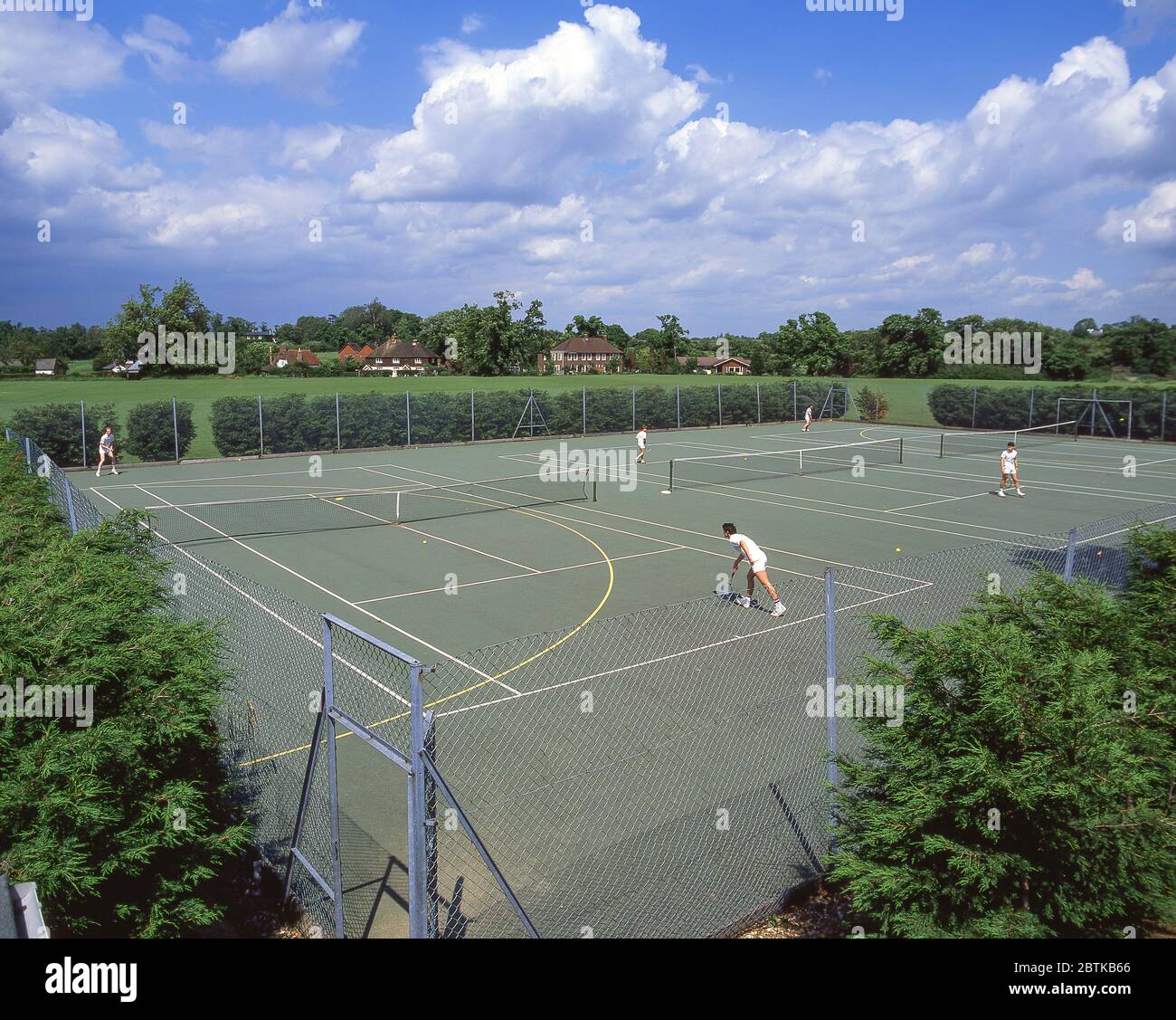 Schoolboys playing on school tennis courts, Surrey, England, United Kingdom Stock Photo