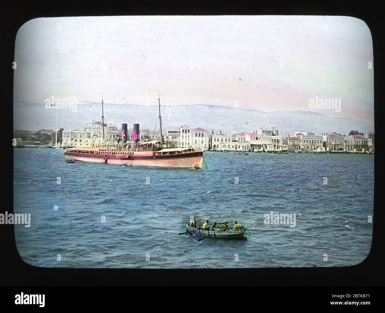 The Dardanelles with waterfront houses, excursion steamer and rowboats. Hand colored slide from around 1910. Photograph on dry glass plate from the Herry W. Schaefer collection. Stock Photo