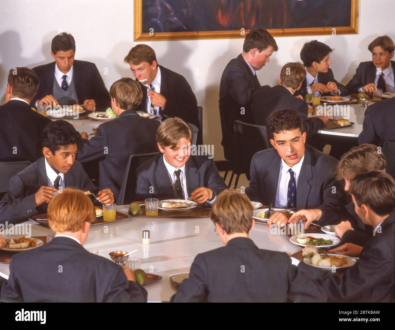 School children eating lunch in school dining hall, Surrey, England, United Kingdom Stock Photo