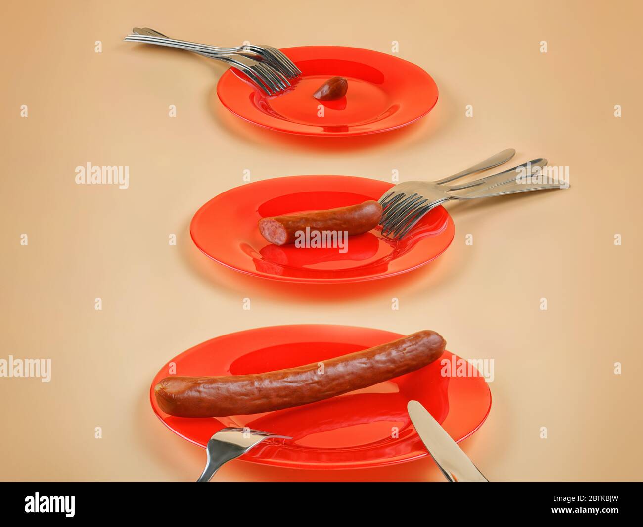Three plates, three different sausage pieces and many forks. Metaphor for disproportion and inequality in allocating budget, wages, resources, funds, Stock Photo