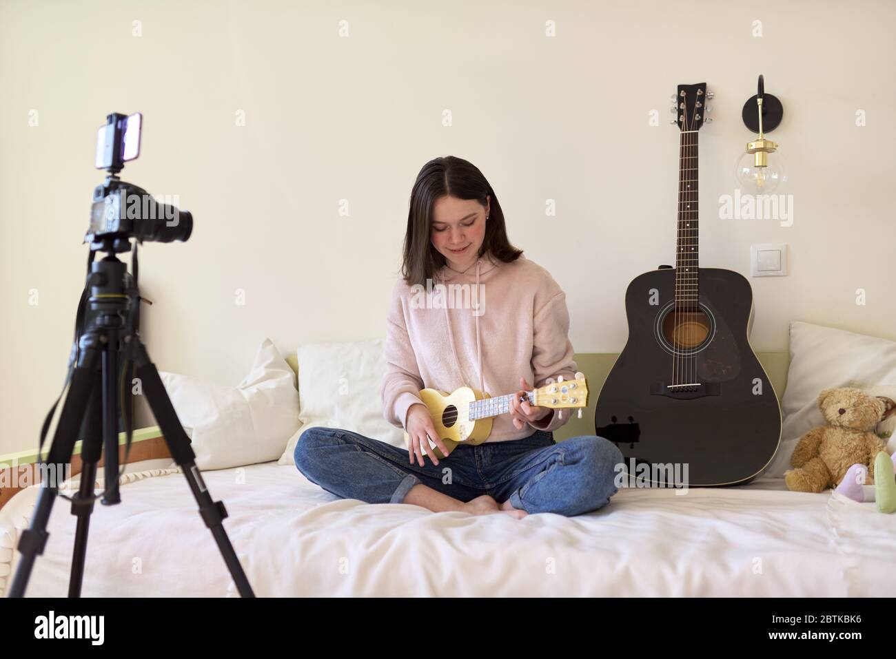 Teen girl playing on ukulele. Blog, music channel, vlog Stock Photo - Alamy
