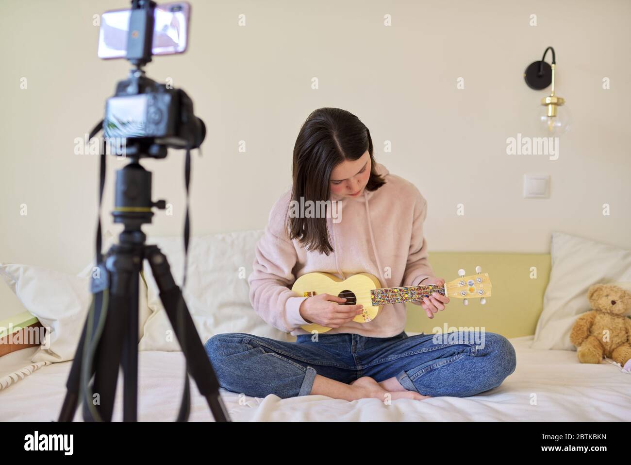 Teen girl playing on ukulele. Blog, music channel, vlog Stock Photo - Alamy