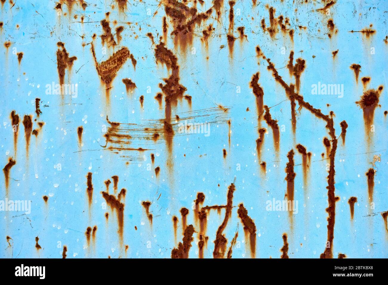 Blue metal surface with brown rusted spots. Stock Photo