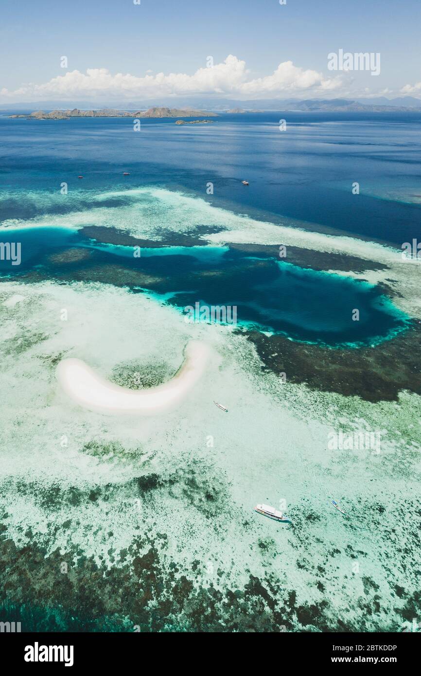 Aerial view of Taka Makassar island in Komodo national park, Indonesia. Empty paradise small white sand island on coral reef. Stock Photo