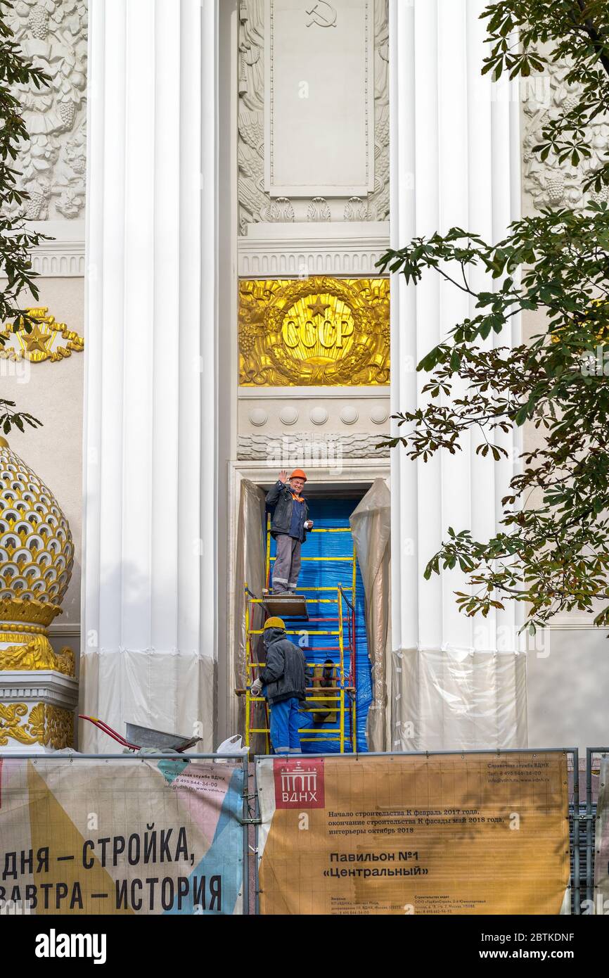 Moscow, Russia - October 09, 2018: reconstruction of Exhibition of Achievements of National Economy-VDNkh.Workers repair the facade and clean the lett Stock Photo