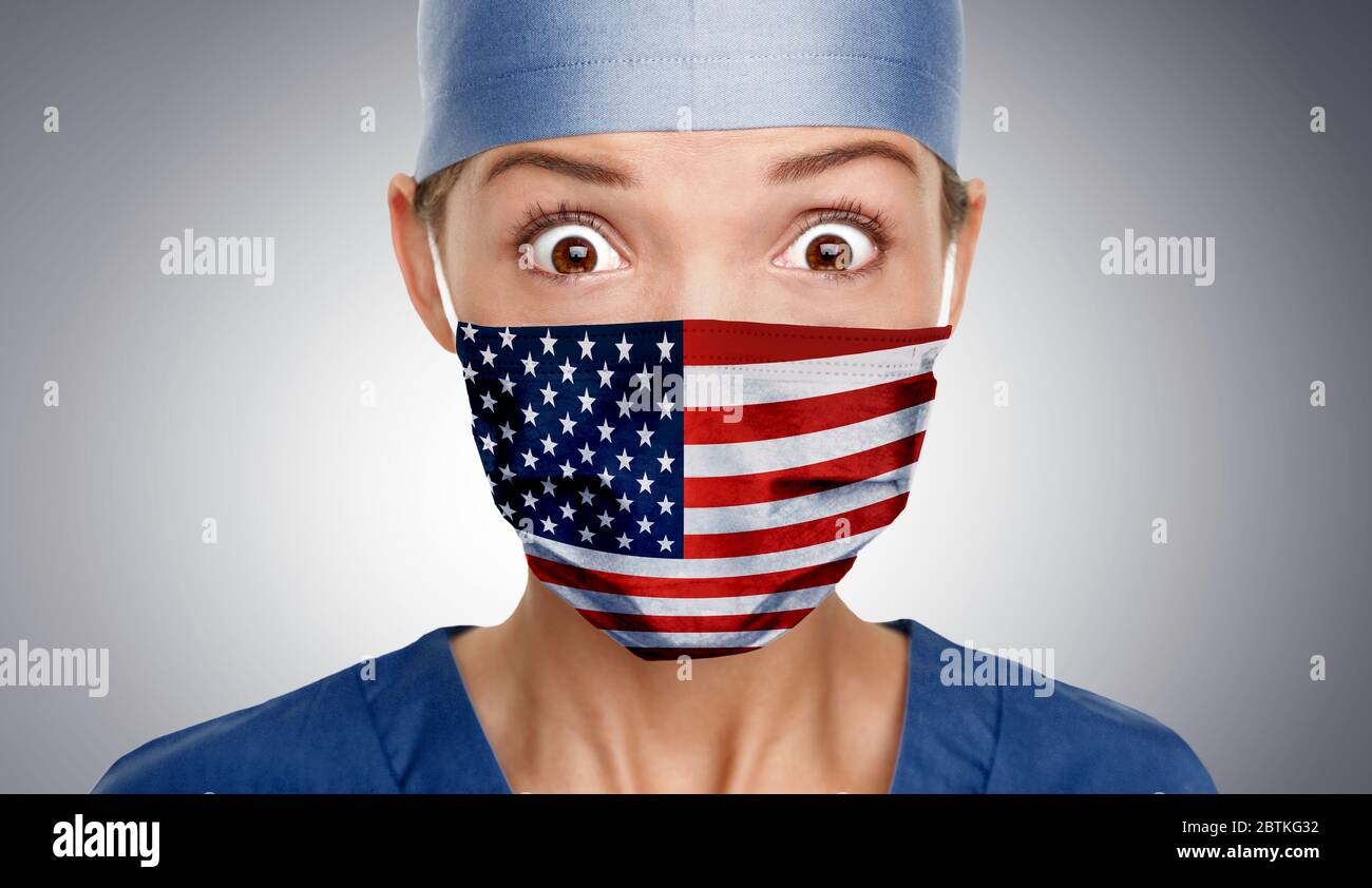 Asian American doctor shocked for COVID-19 crisis help with USA flag on surgical mask. Healthcare workers needing PPE help to fight COVID-19 Coronavirus . Stock Photo