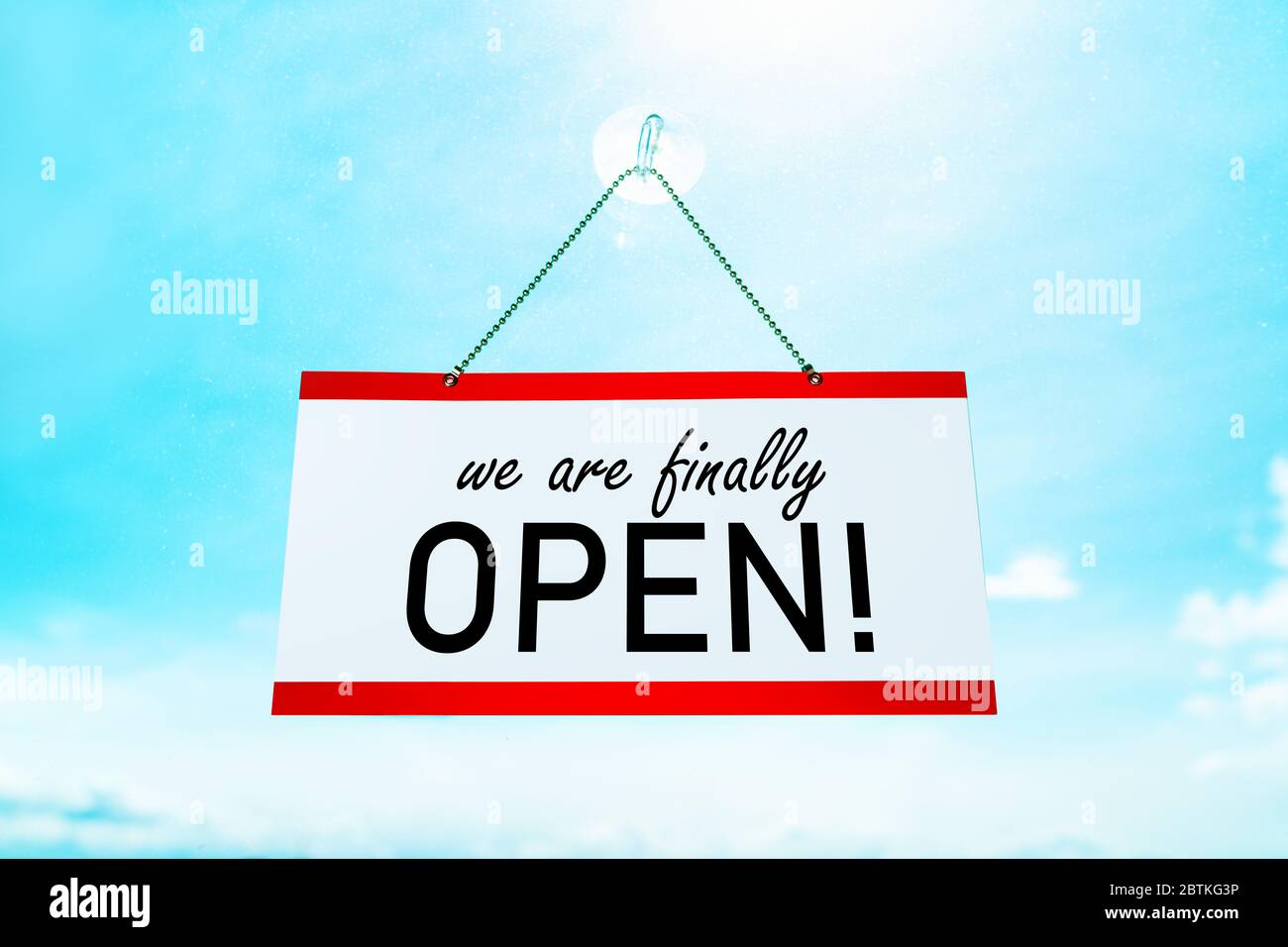 COVID19 WE'RE FINALLY OPEN ! sign hanging on window store end of