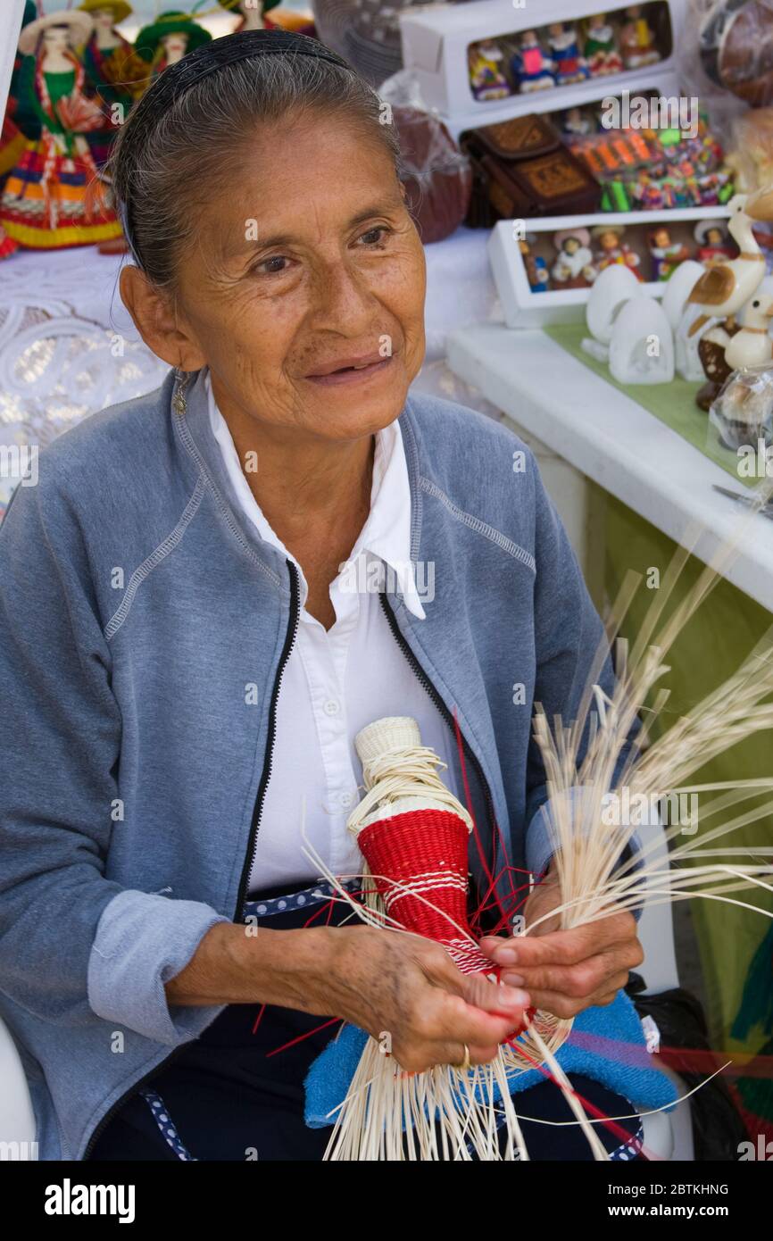Woman making straw dolls in Montecristi colonial town, City of Manta