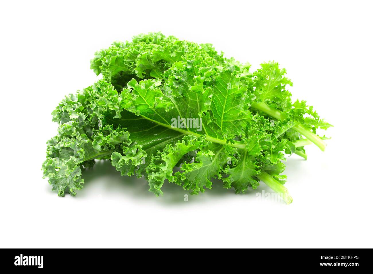 Fresh raw organic green kale leaf heap on white isolated background. Kale is healthy Superfood for diet, have omega 3, protein, vitamins and mineral. Stock Photo