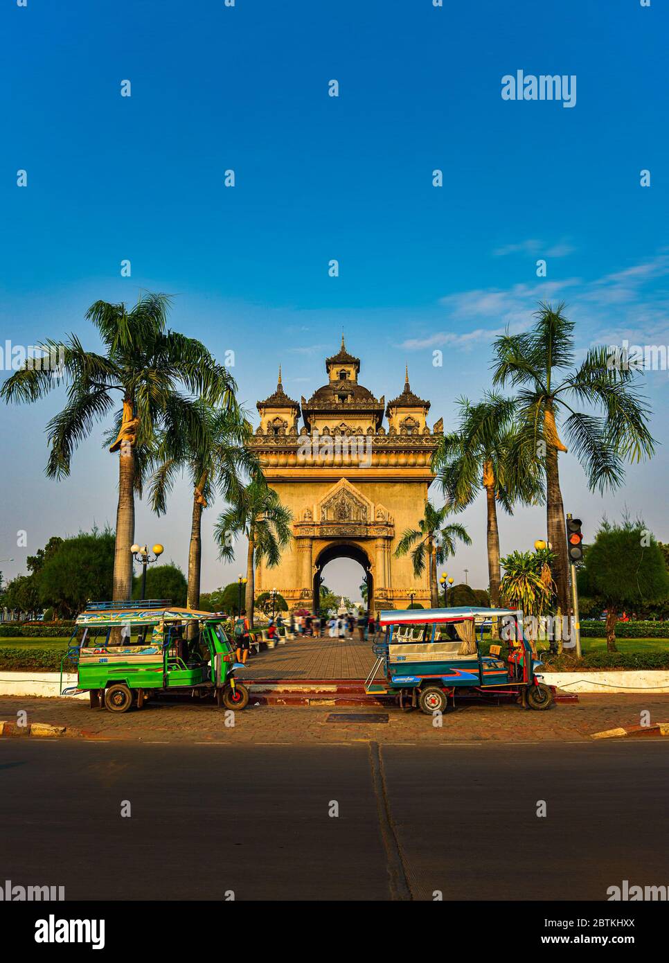 Auto rickshaw in front of the Patuxai Monument in Vientiane Laos Stock Photo