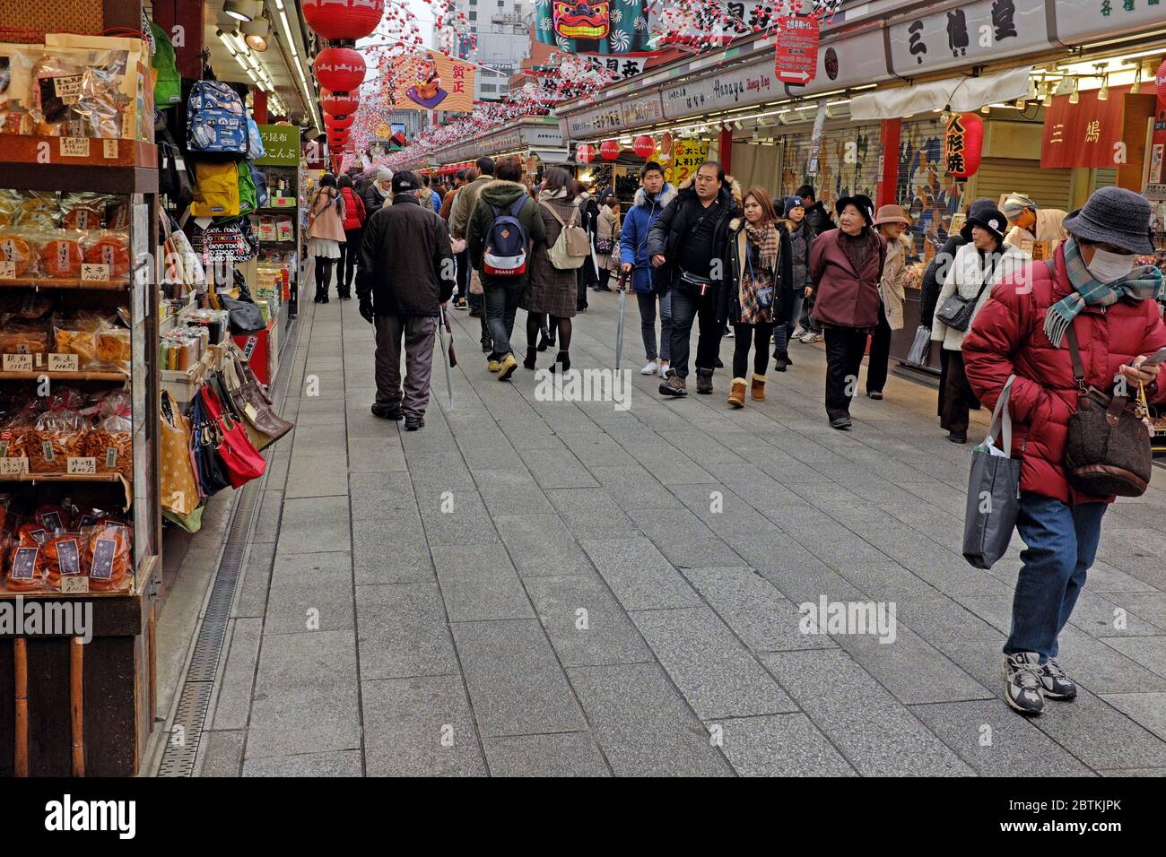 Shoppers along historic Nakamise Street in the Sensoji Temple grounds in Asakusa, Japan on January 11, 2016 Stock Photo
