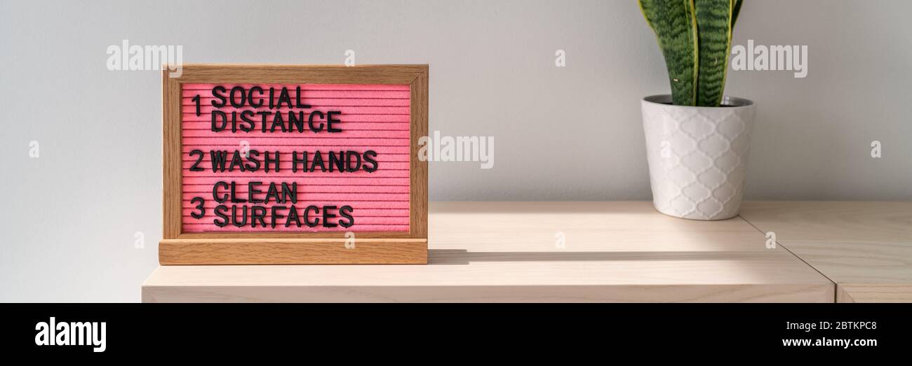 COVID-19 hygiene practices for Coronavirus prevention banner. Text board in public space with rules, practice social distancing, wash hands often, clean surfaces, sanitizing surfaces. Stock Photo