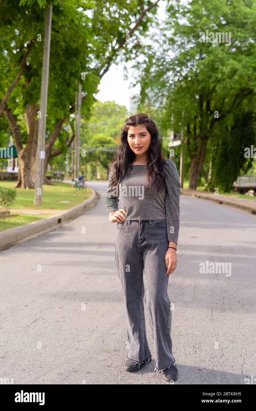 Full body shot of young beautiful Indian woman in the streets at the ...