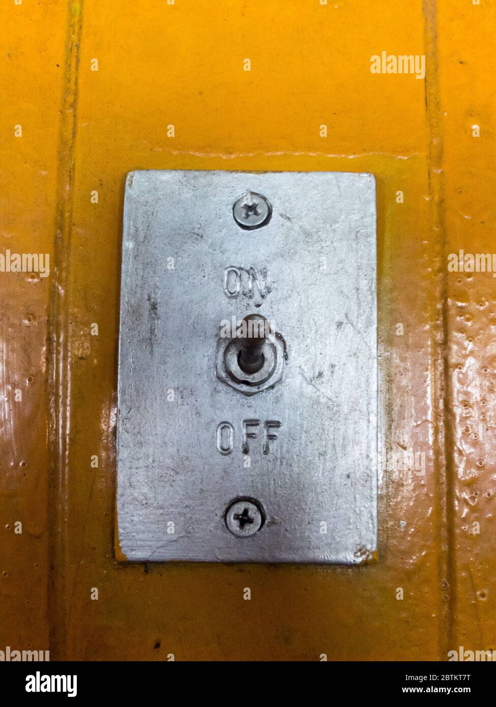 Switch off and on. On the old yellow wood floor Stock Photo - Alamy