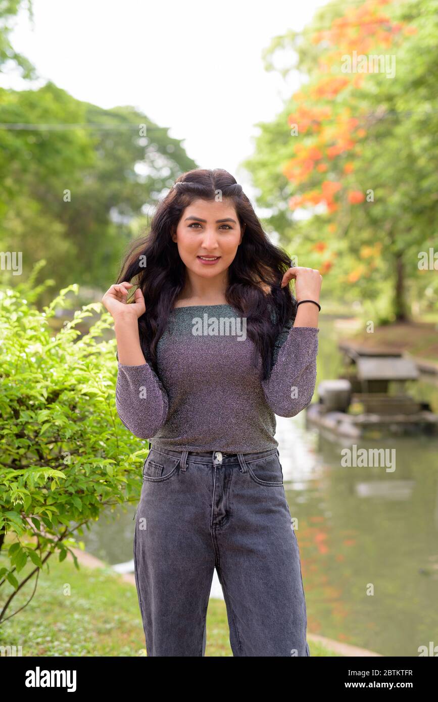 Happy young beautiful Indian woman smiling at the park outdoors Stock ...