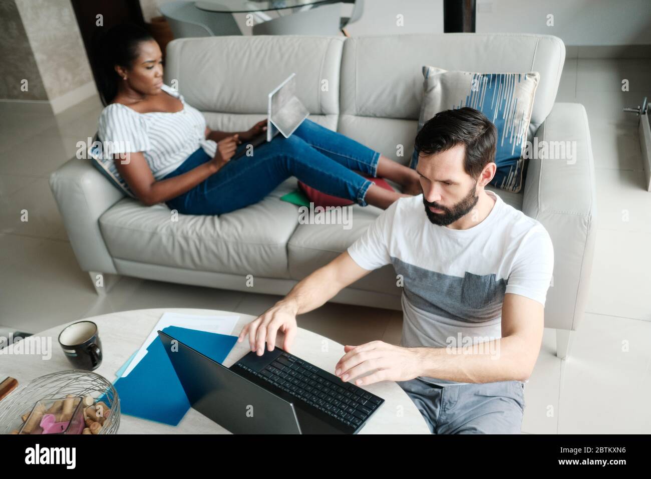 Couple Working And Playing With Laptop Computer At Home Stock Photo