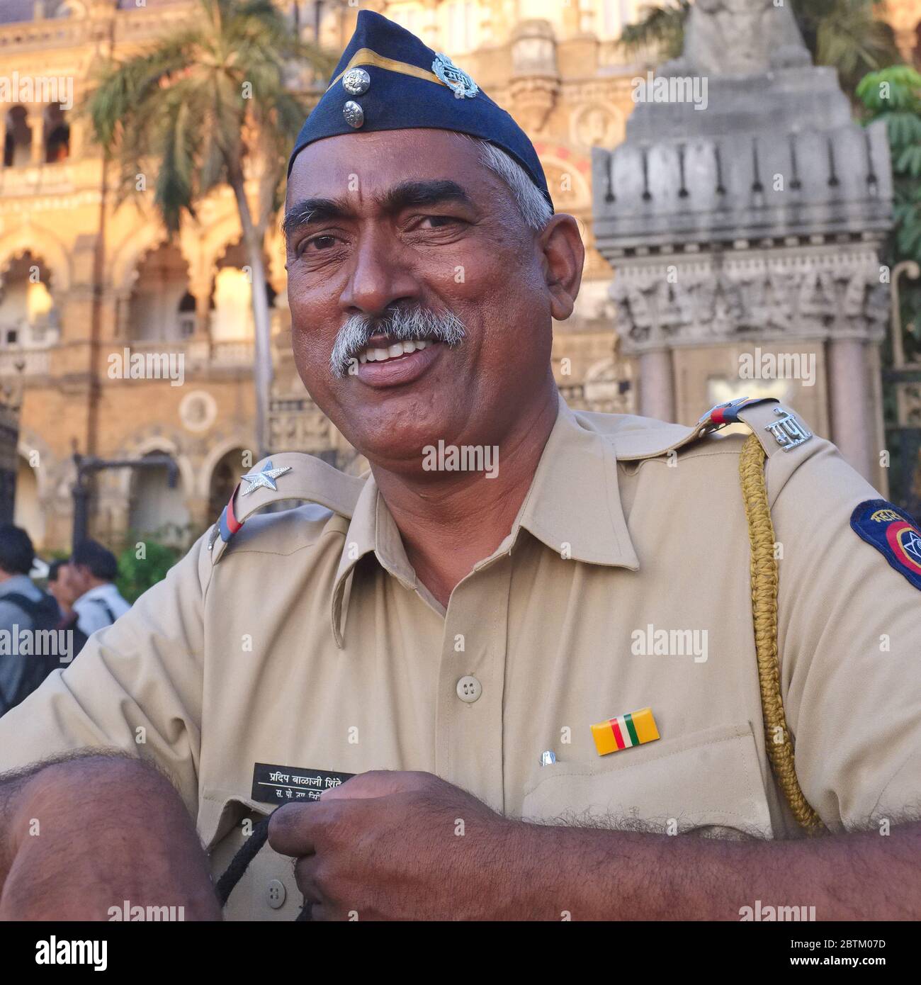 A friendly, smiling traffic policeman (an ethnic Maharashtrian) in front of Chhatrapati Shivaji Maharaj Terminus in Mumbai, Maharashtra, India Stock Photo