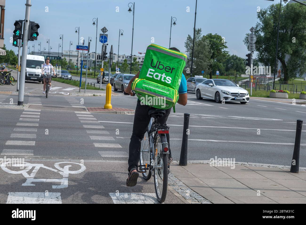 WARSAW, POLNAD - June 15, 2019: UberEATS cycle delivery courier. Uber Eats delivery in progress on Warsaw street - Poland. UberEATS is online food ord Stock Photo