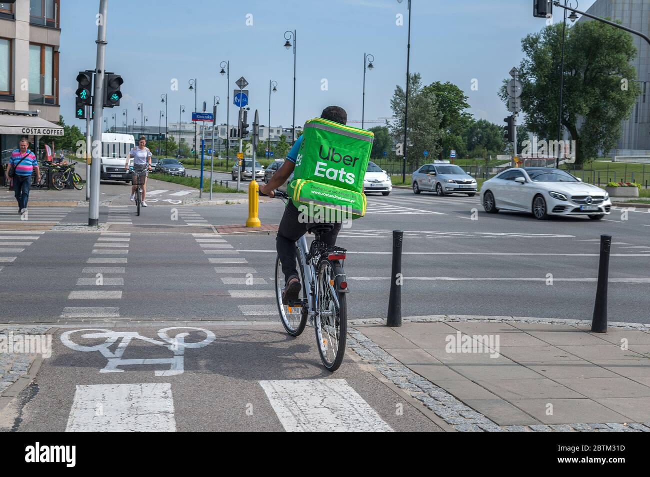 WARSAW, POLNAD - June 15, 2019: UberEATS cycle delivery courier. Uber Eats delivery in progress on Warsaw street - Poland. UberEATS is online food ord Stock Photo