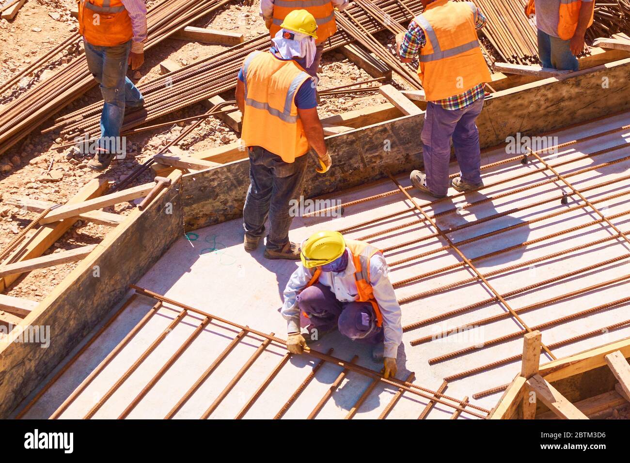 Workers are building concrete reinforced foundation plate at ...