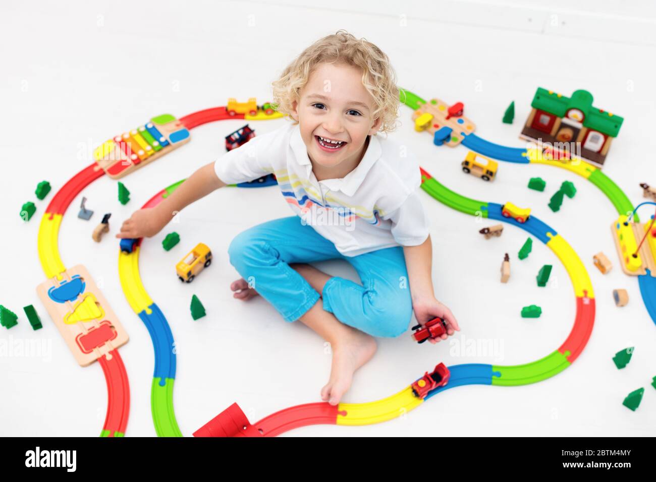 Kids Play With Toy Train Railway Child Playing With Colorful Rainbow Wooden Trains Toys For Little Boy Preschooler Building Rail Road At Home Or Da Stock Photo Alamy