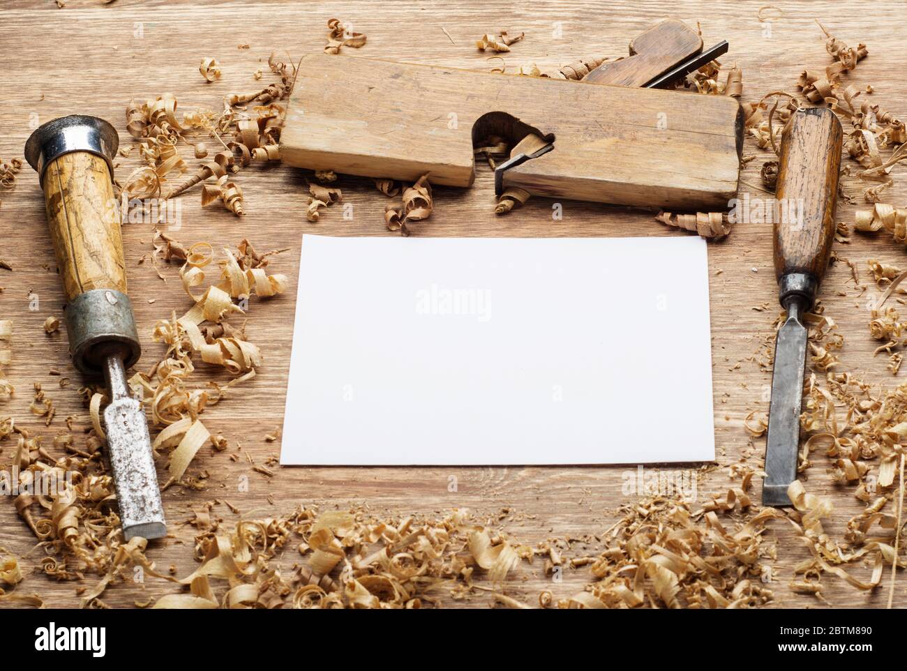 carpenter tools on dark rustic table with blank paper. Stock Photo