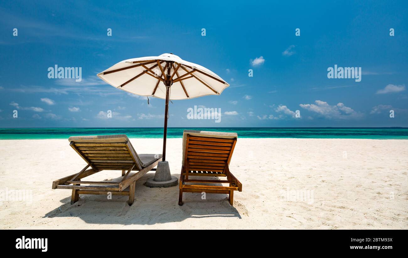 Beautiful tropical beach banner. White sand and coco palms travel tourism wide panorama background concept. Amazing beach landscape, luxury island Stock Photo