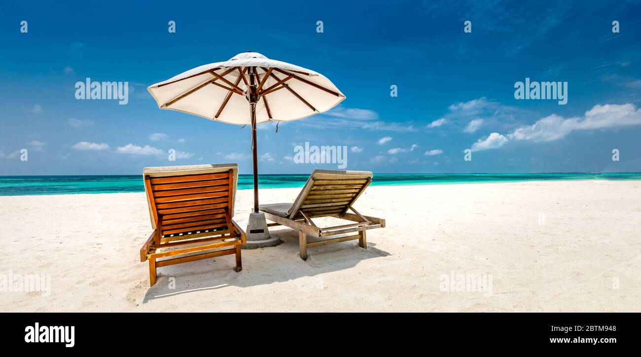 Beautiful tropical beach banner. White sand and coco palms travel tourism wide panorama background concept. Amazing beach landscape, luxury island Stock Photo