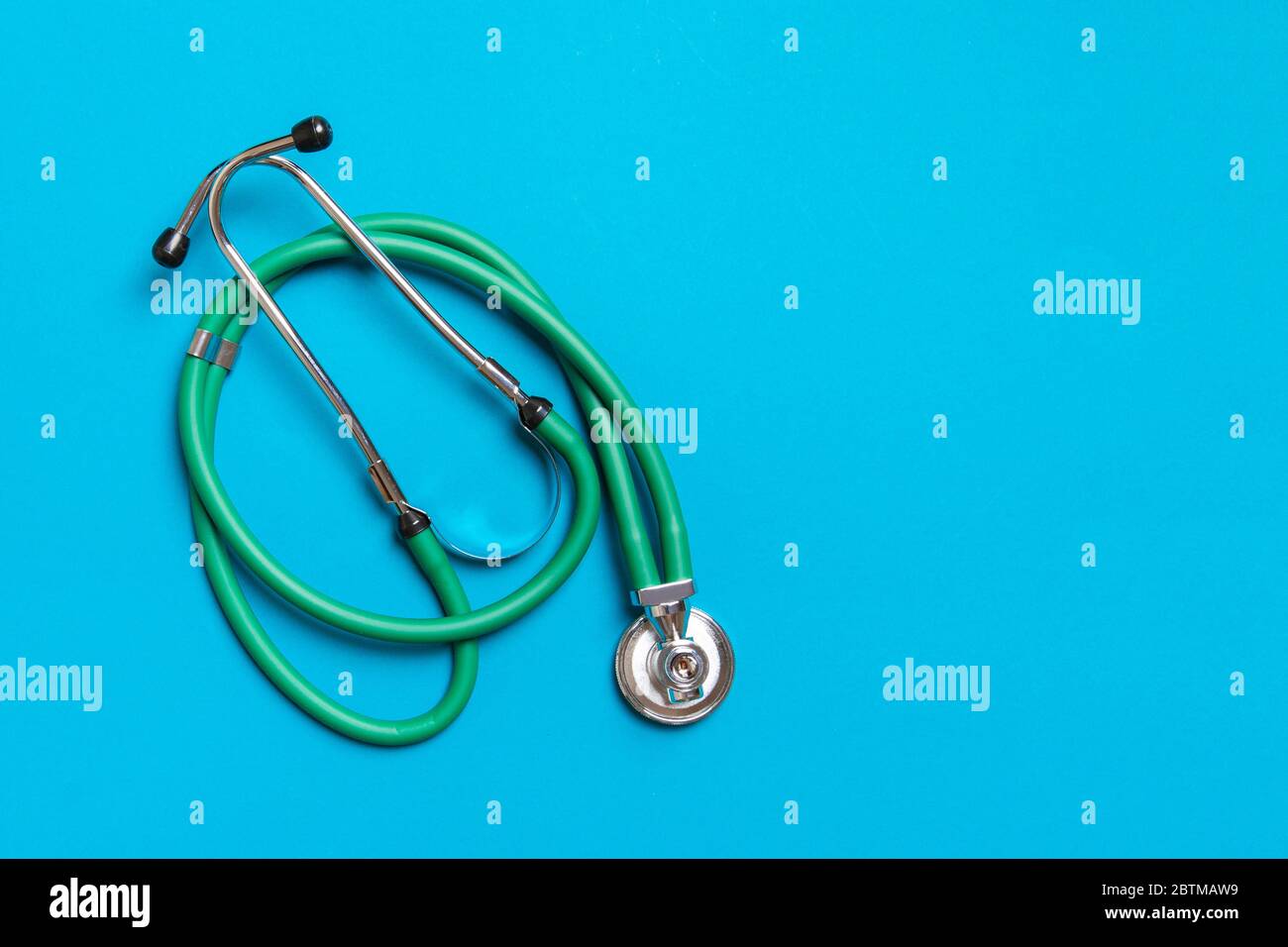 Top view of green medical stethoscope on colorful background with copy ...
