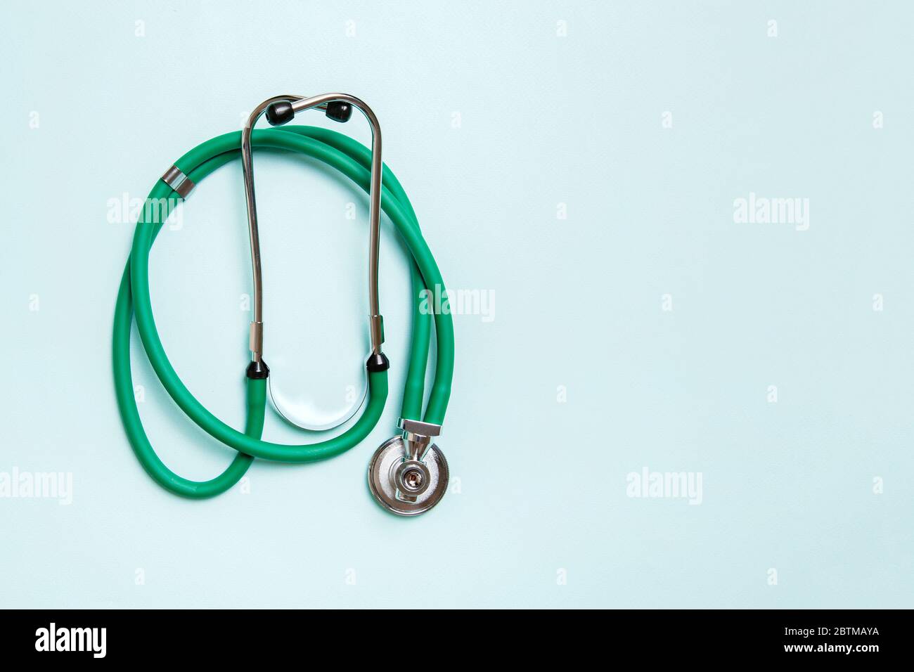 Top view of green medical stethoscope on colorful background with copy ...