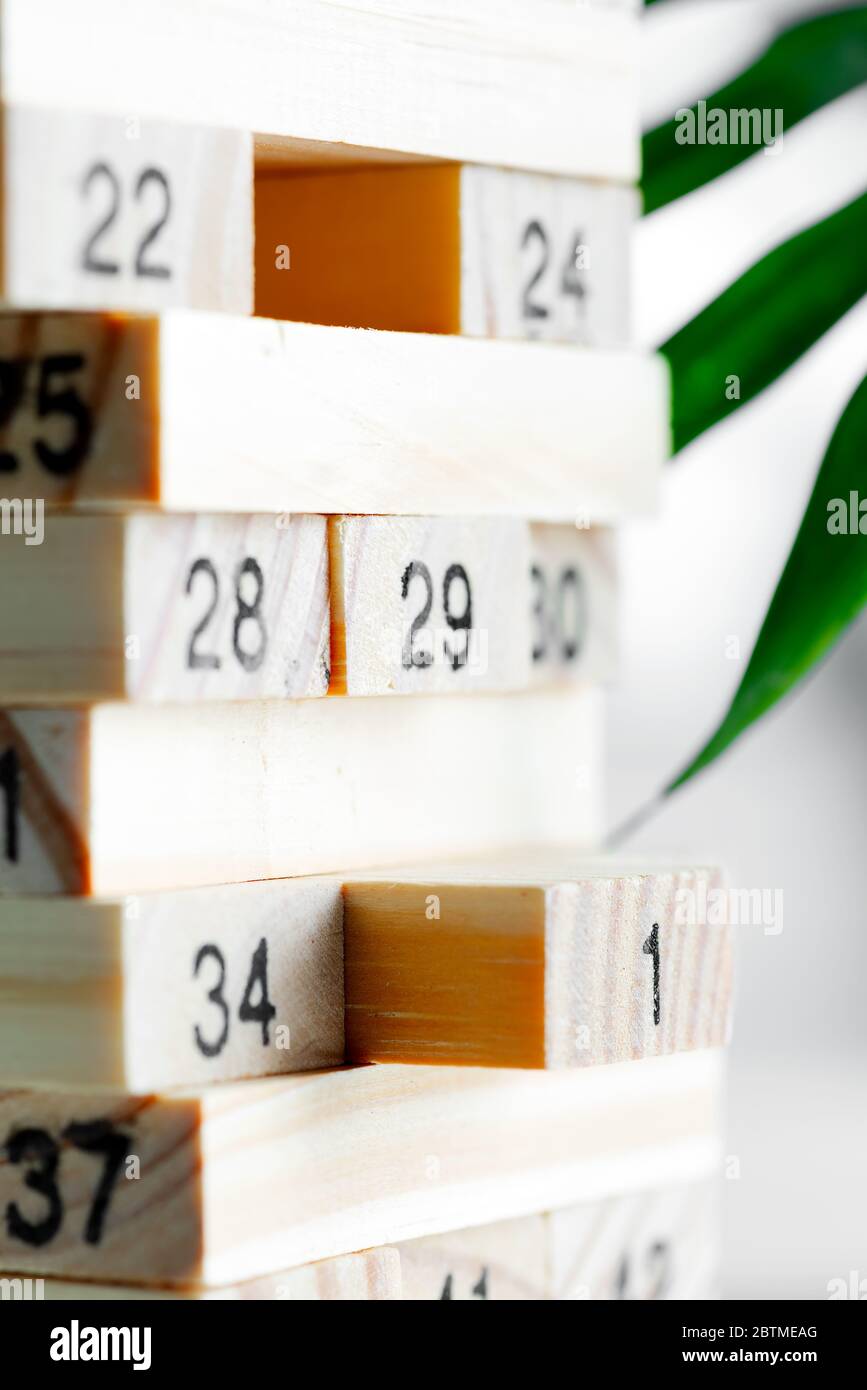 Creative game Jenga from wooden blocks with numbers for children