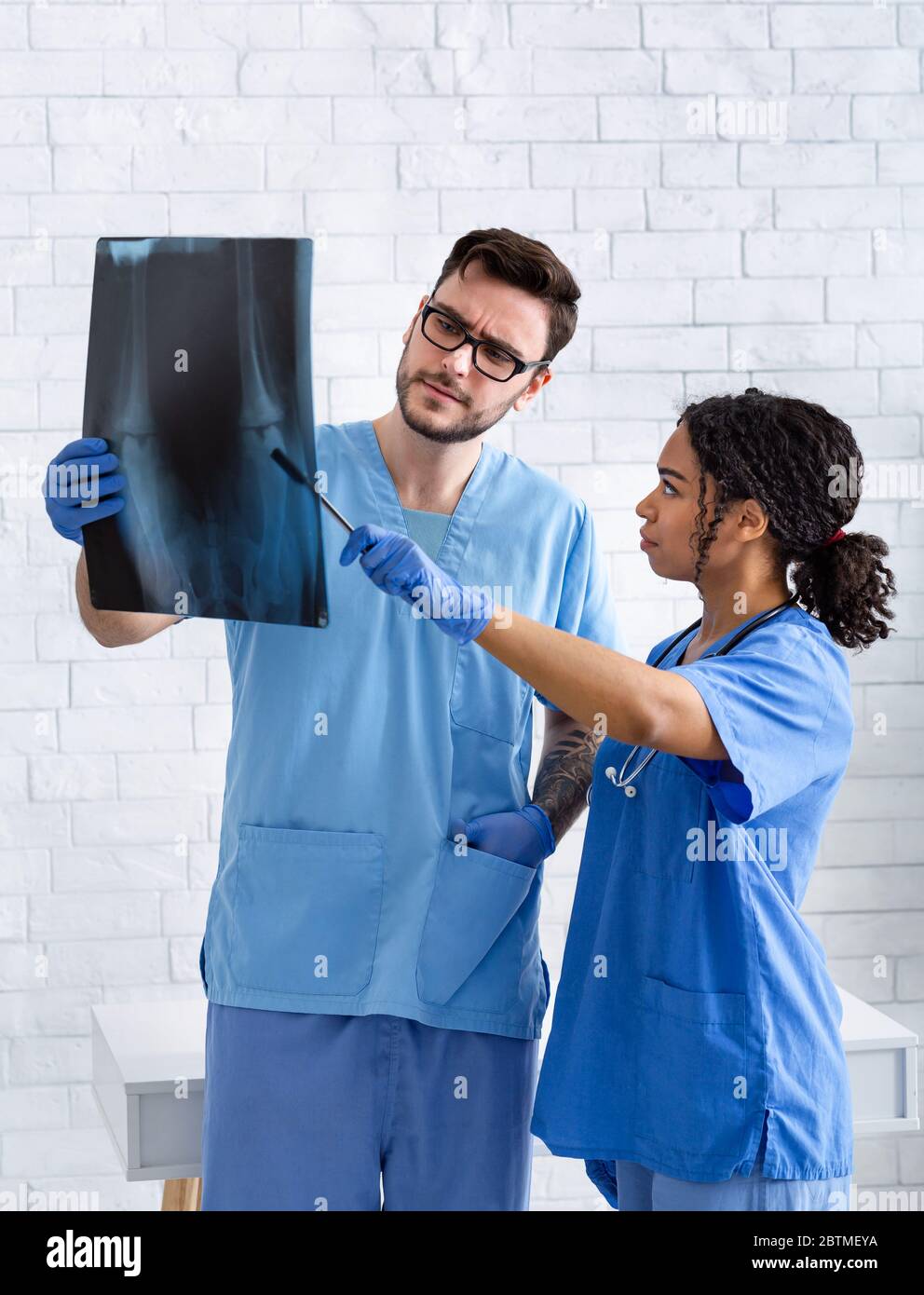 Animal radiology. Veterinarian doctor with assistant studying xray at