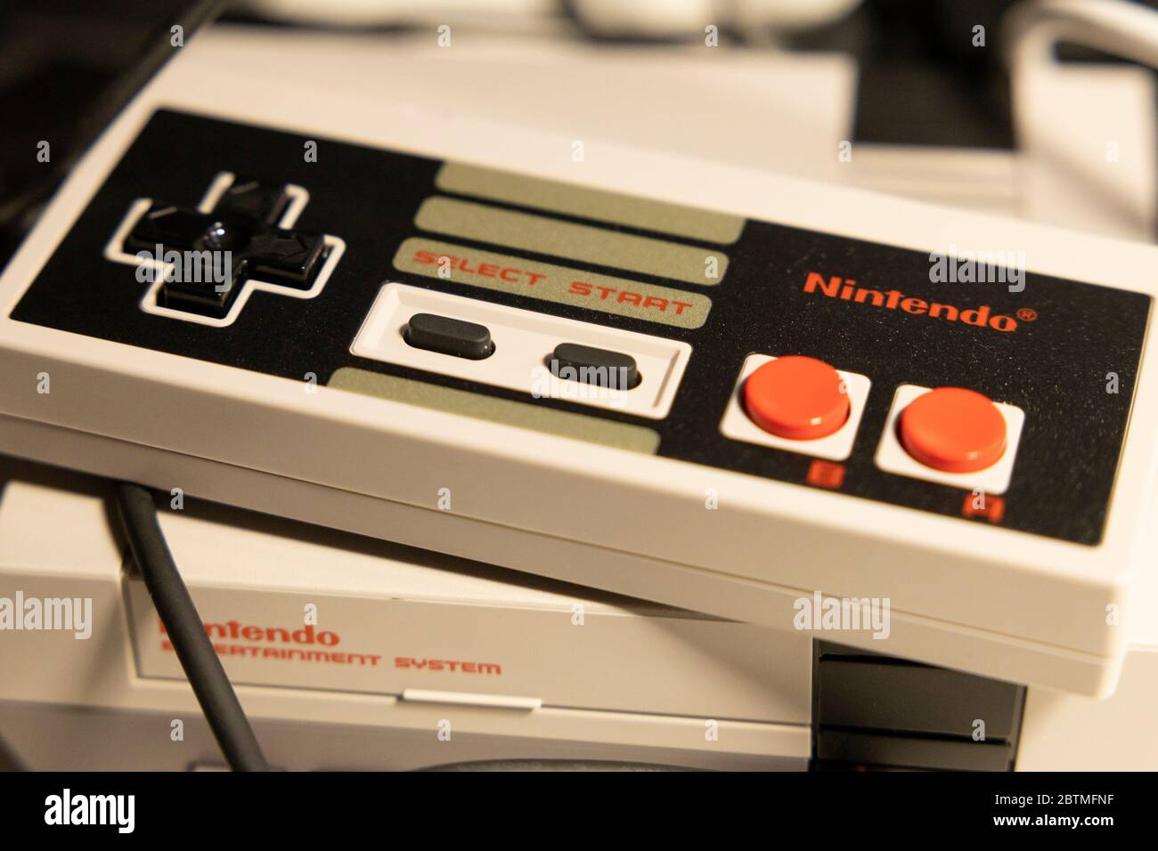 Retro gaming trend with a Nintendo controller and NES mini Stock Photo