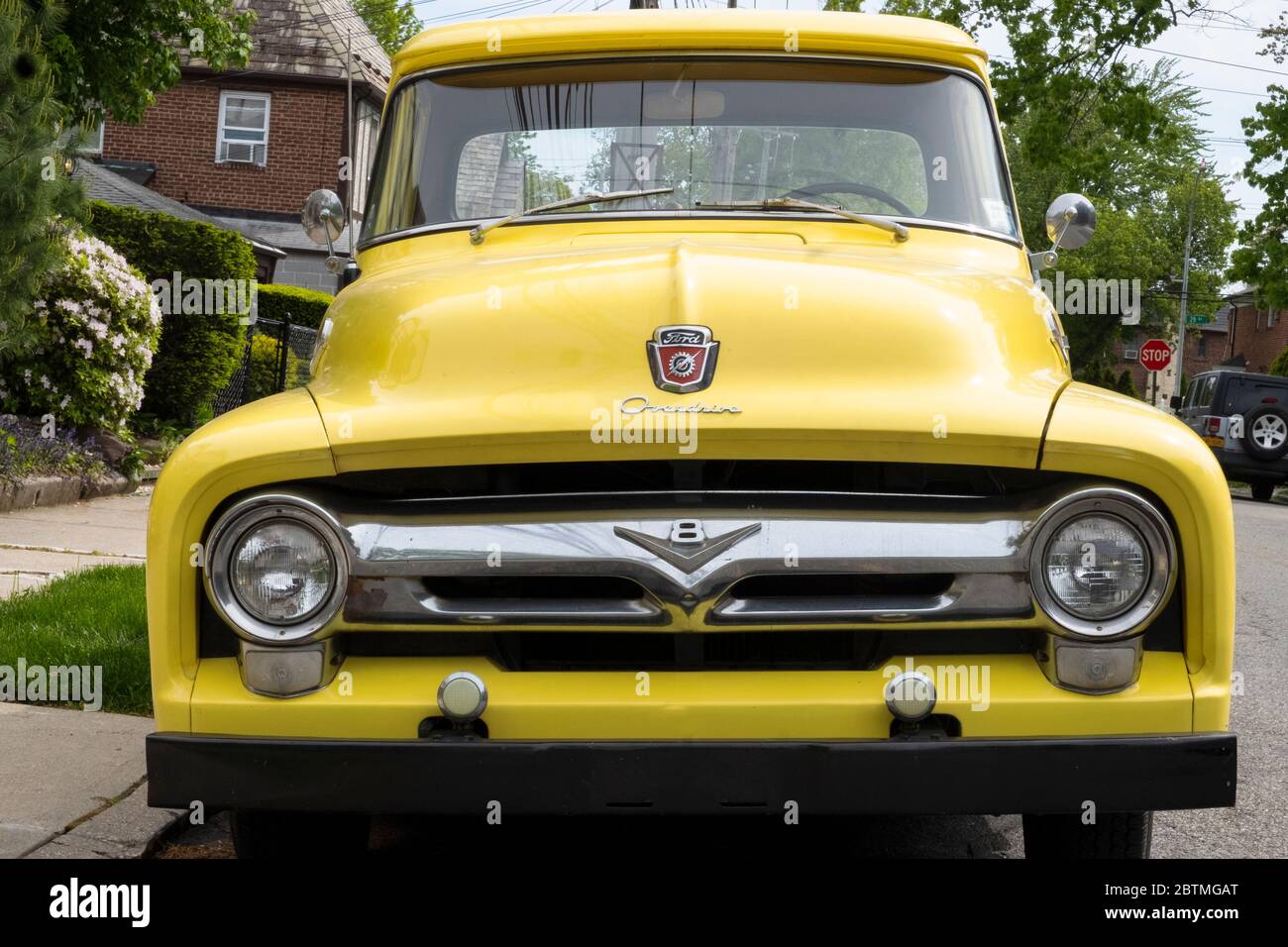 A refurbished 1956 Ford Overdrive pickup truck parked on a quiet