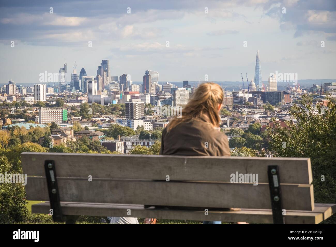 Back view of a tourist looking at London city skyline from Parliament