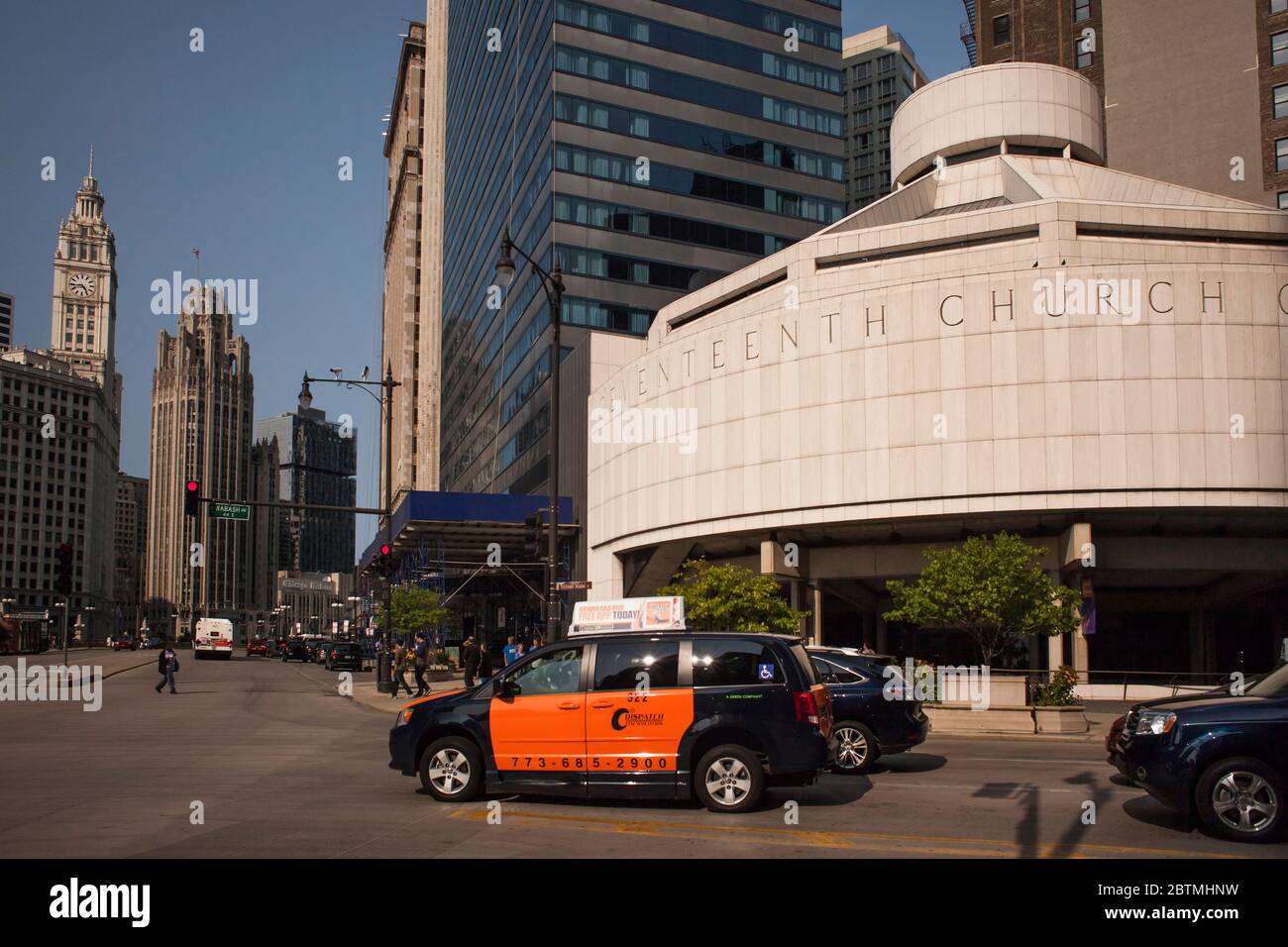 E. Wacker Drive at Wabash Ave with cars, including an orange and black taxi, passing by Seventeenth Church of Christ Scientist, Chicago Loop, Illinois Stock Photo