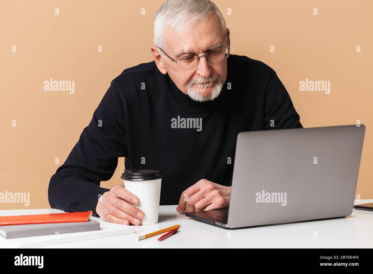 Attractive senior man working in hi-res stock photography and images ...