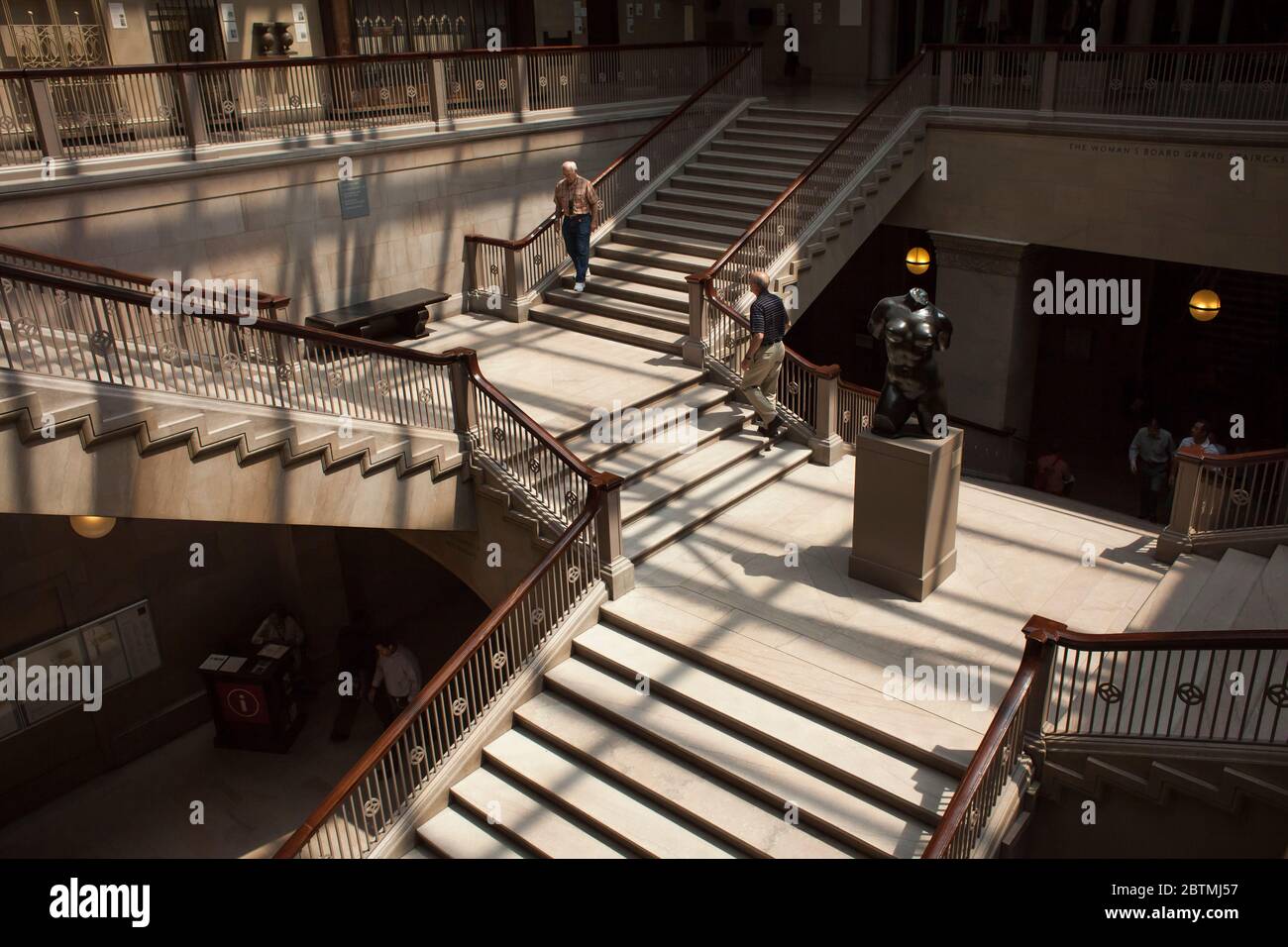 Woman’s board Grand staircase of the Chicago Arts Institute museum with one man going down and another one going up, Chicago, Illinois, USA Stock Photo