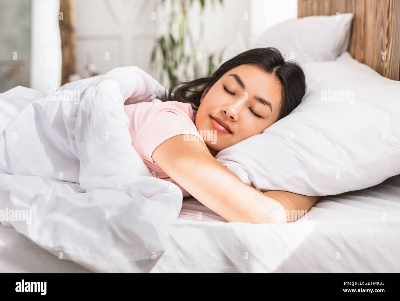 Asian Girl Sleeping Hugging Pillow Resting In Comfortable Bed Indoors Stock Photo Alamy