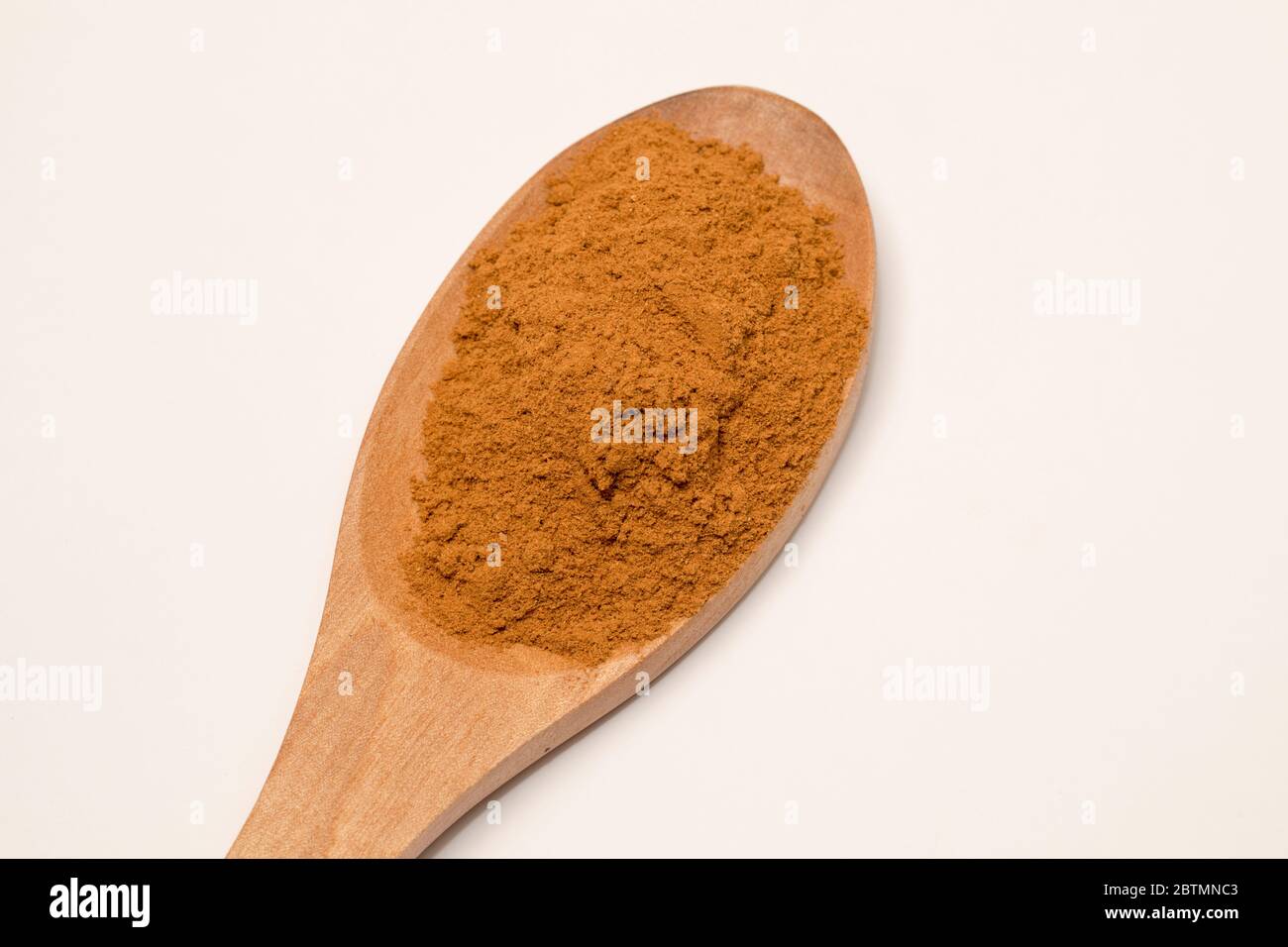 Close-up view of cinnamon powder on white background. Stock Photo