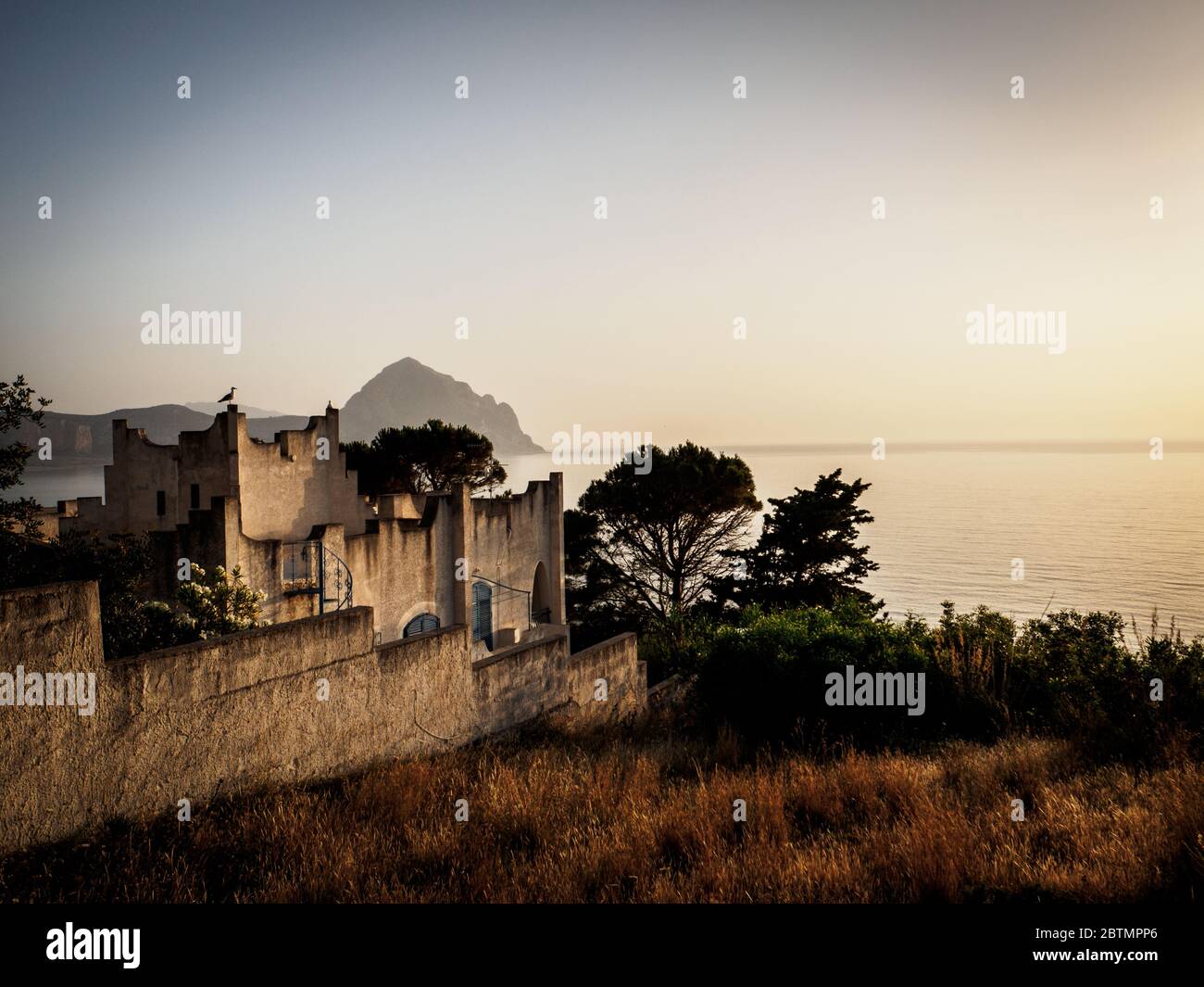 enjoying the sunset on the coast of sicily with a beautiful italian villa Stock Photo