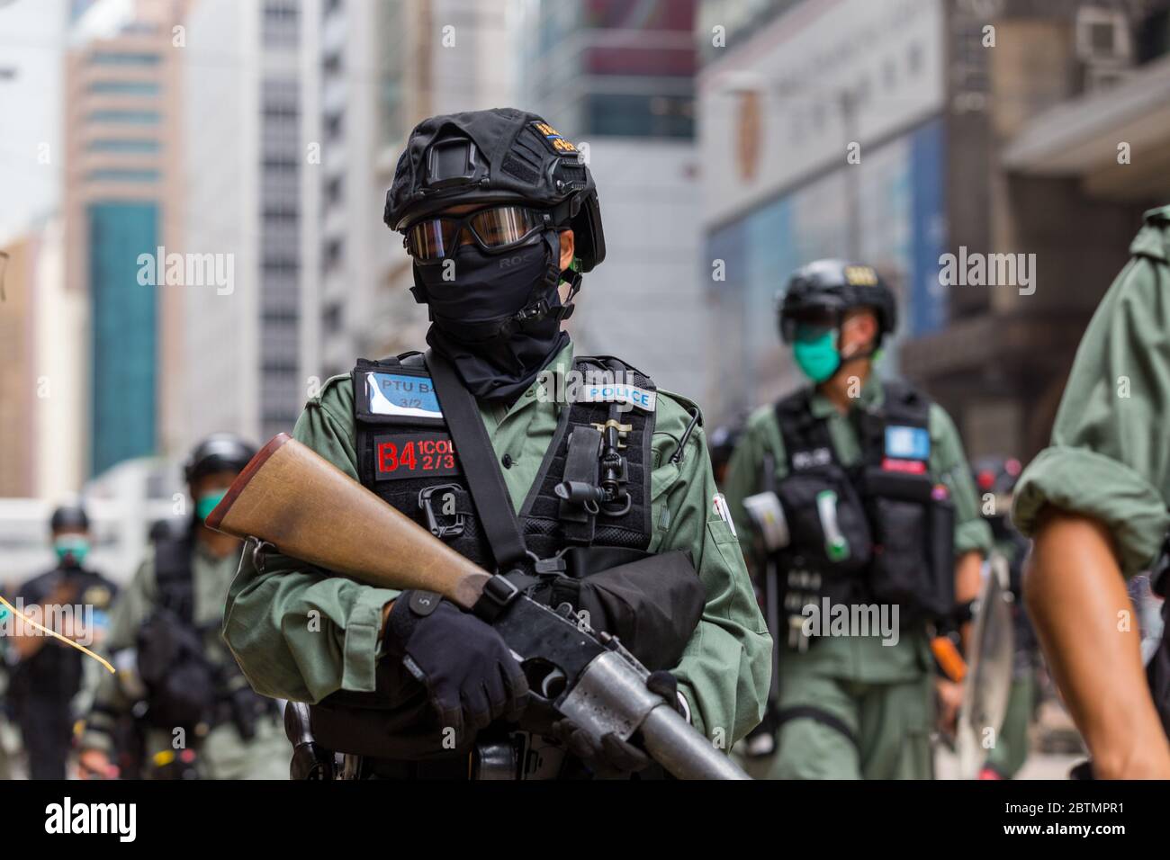 Central, Hong Kong. 27 May, 2020 Hong Kong Protest Anti-National Anthem Law. Police officer carrying the tear gas gun. Credit: David Ogg / Alamy Live News Stock Photo