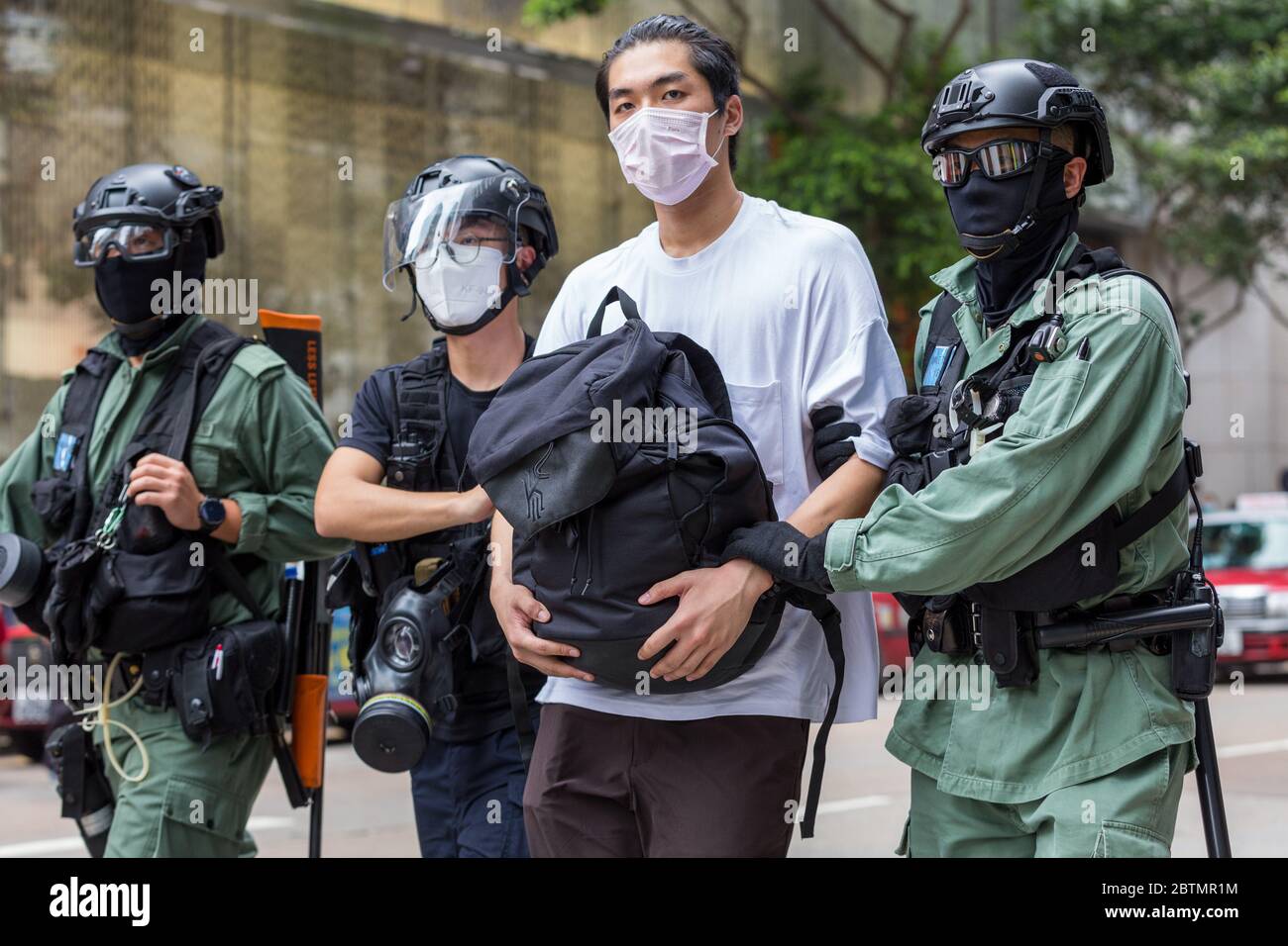 Central, Hong Kong. 27 May, 2020 Hong Kong Protest Anti-National Anthem Law. Police taking an arrested individual to the police van. Credit: David Ogg / Alamy Live News Stock Photo