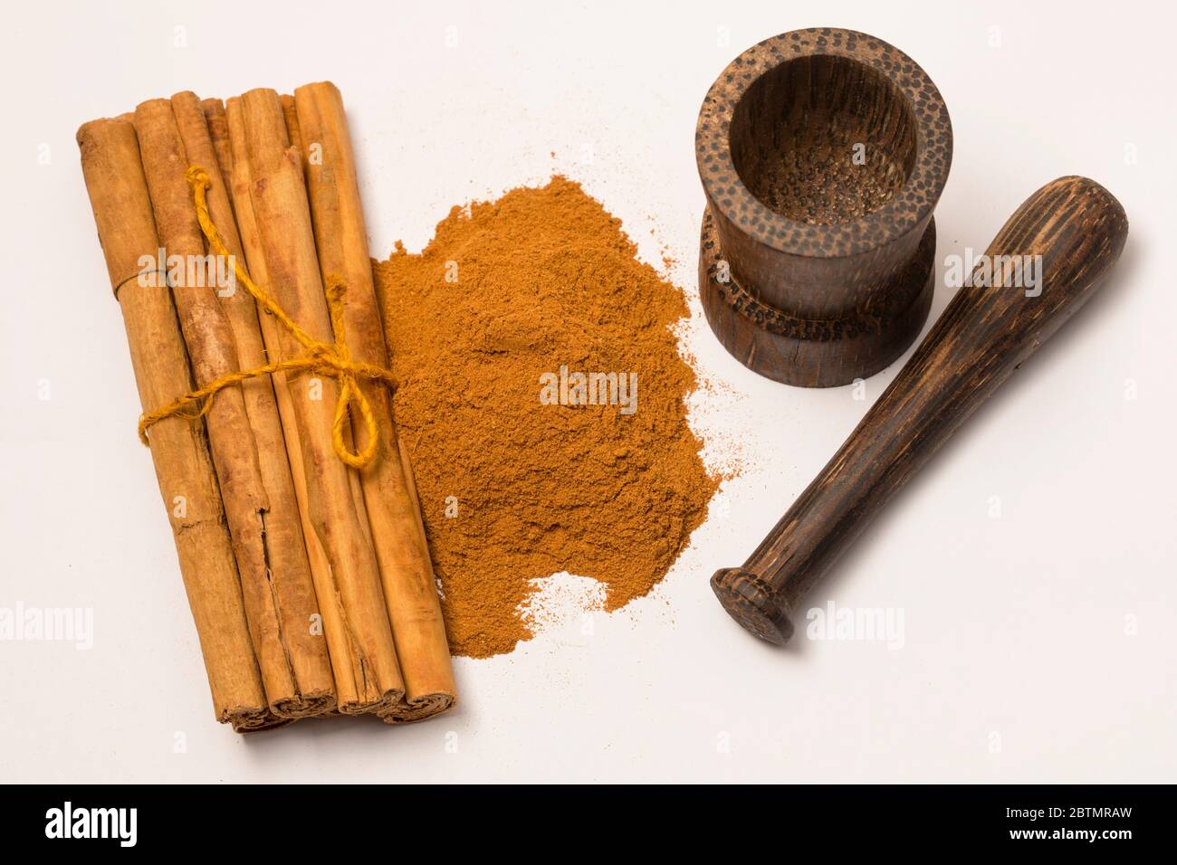 Close-up view of cinnamon sticks and powder on white background. Stock Photo