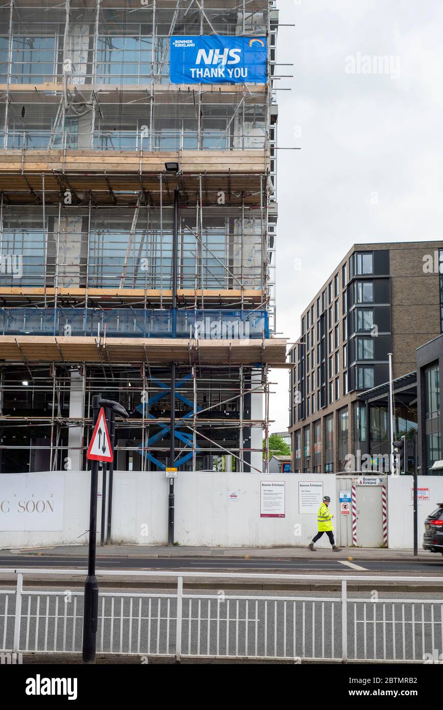 Sheffield UK –  April 09 2020: A sign thanking the NHS hangs from a towerblock under construction during the coronavirus Covi-19 lockdown, New Era Squ Stock Photo