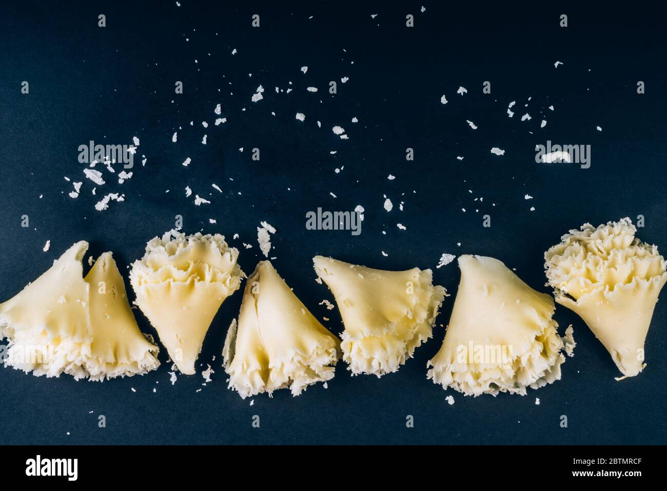 https://c8.alamy.com/comp/2BTMRCF/swiss-cheese-tete-de-moine-or-monastery-monks-head-scraped-with-a-girolle-special-knife-rosettes-on-a-dark-slate-background-copy-space-selective-2BTMRCF.jpg