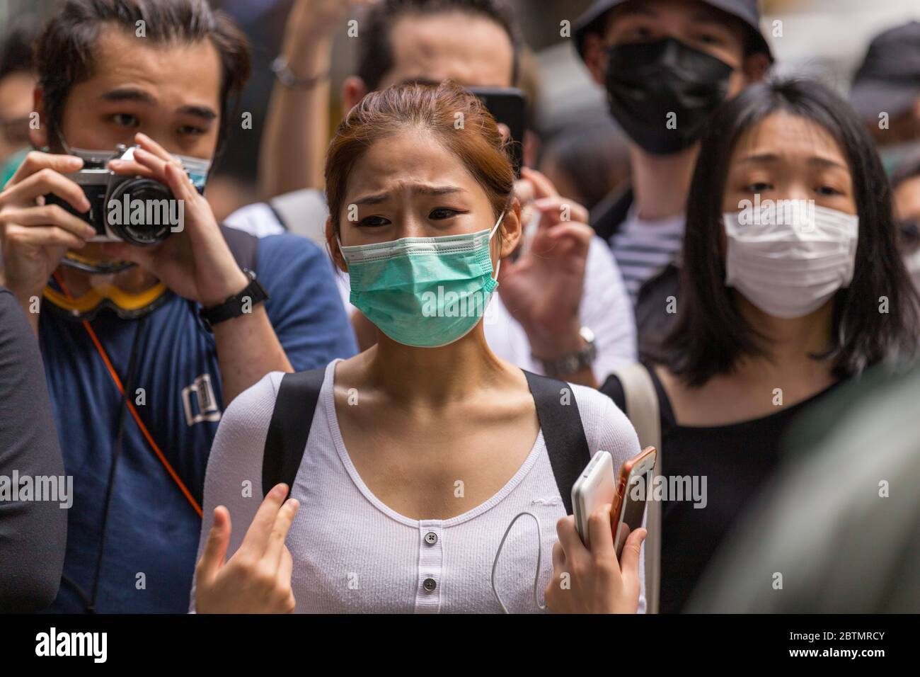 Central, Hong Kong. 27 May, 2020 Hong Kong Protest Anti-National Anthem Law. A visibly upset Hong Kong woman argues with the police. Credit: David Ogg / Alamy Live News Stock Photo